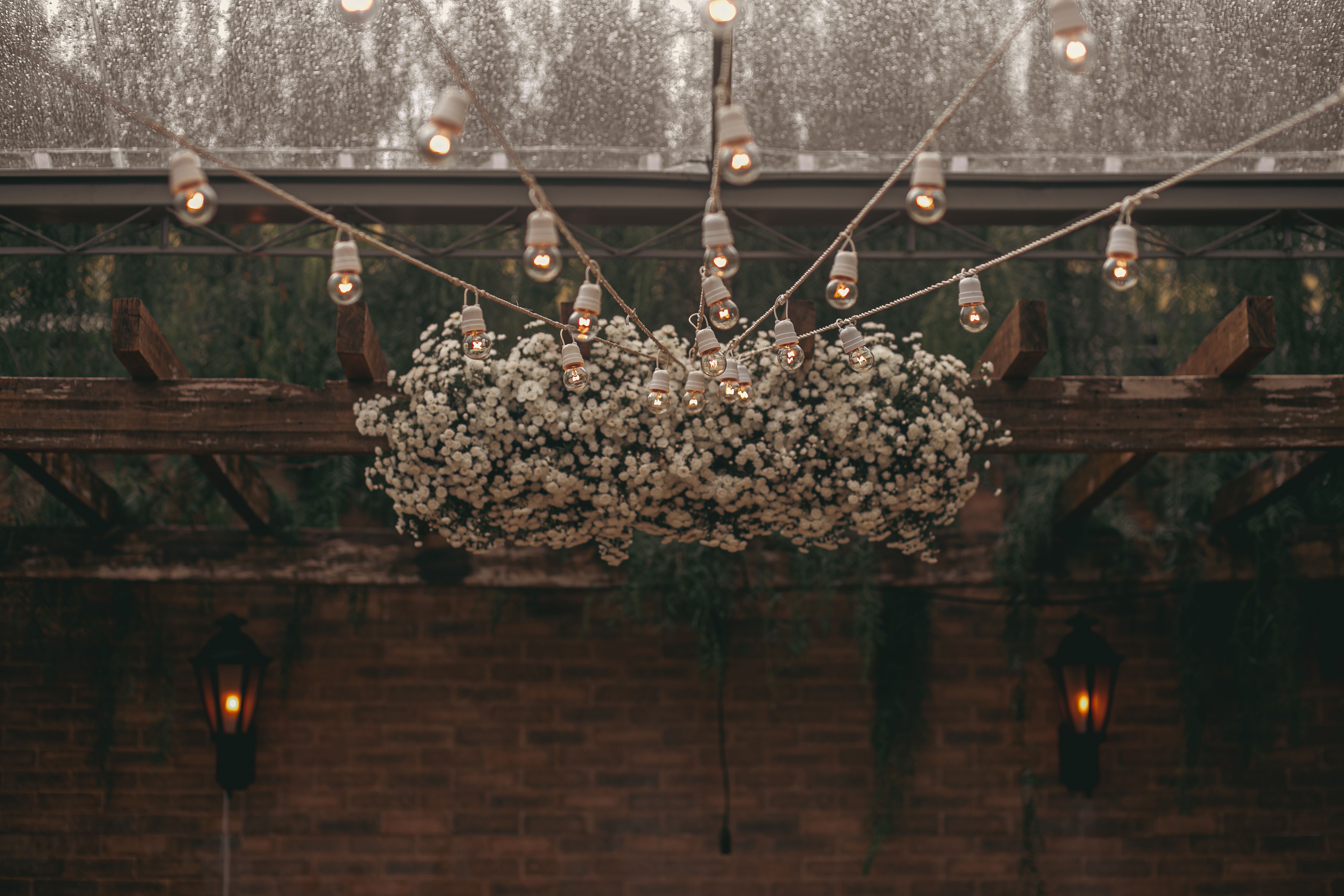 Wooden backyard pergola decorated with string lights for a cozy evening atmosphere.