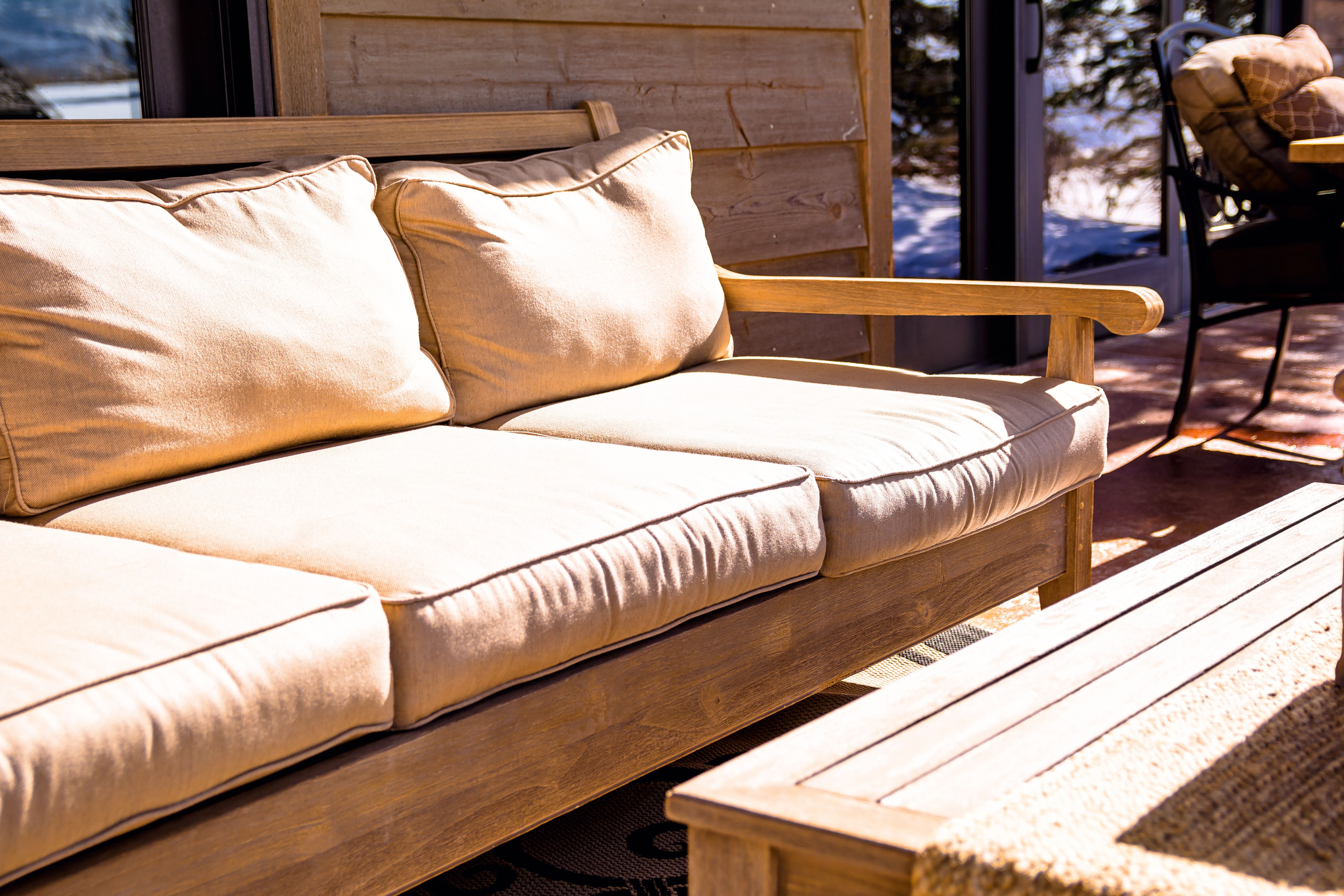 Comfortable backyard patio seating with cushions for relaxed outdoor living.